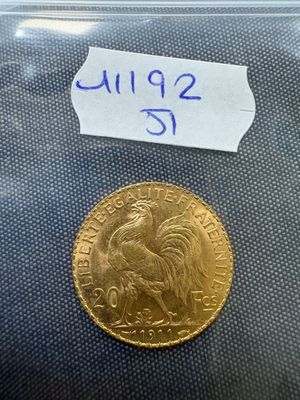 a close up of a gold coin with a label on it