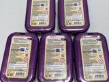 four purple tins of soap sitting on top of a white table