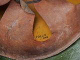 a close up of a brown shoe with a yellow tag on it