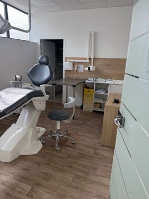 a room with a table, chair, and other medical equipment in it