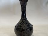 a black vase that is sitting on a table