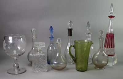 many different types of glass bottles and vases on the table