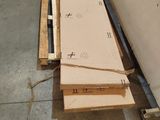 a pile of cardboard sitting on the floor next to a wall