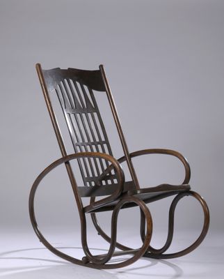 an old rocking chair with a wooden seat on a white surface