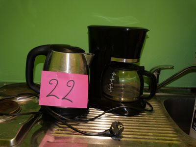 a coffee maker and a coffee pot on a counter