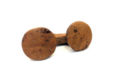 pair of wooden knobs on a white surface with a white background