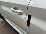 a close up of a car door handle with a sticker on it