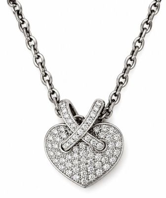 a close up of a diamond heart pendant on a chain