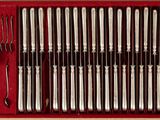 many forks and spoons in a red box