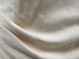 a close up of a person wearing a white shirt and black pants