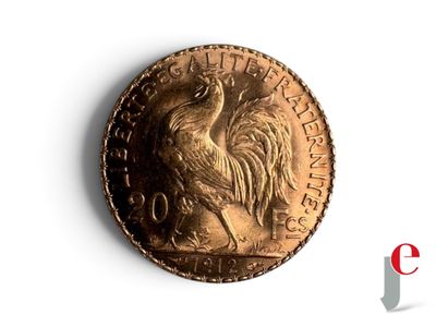une pièce d'or sur laquelle est représenté un coq, sur un fond blanc