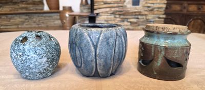 three vases sitting on a table next to each other