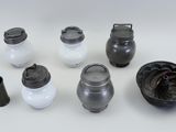 many different types of pots and containers on the table