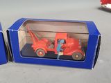 two boxes with toy cars in them on a table