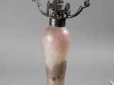 a small vase with a flower in it sitting on a table