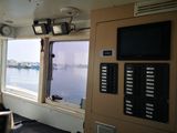a man sitting in a chair on a boat looking out the window