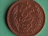 a close up of a coin on a green surface