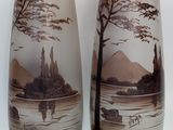 two vases that are sitting side by side on a table