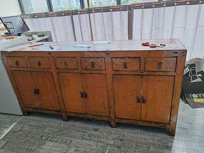 an old wooden cabinet in the middle of a room