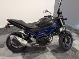 a black and blue motorcycle parked on a checkered floor