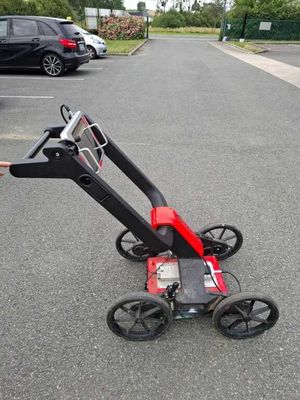 a person pushing a cart with wheels in a parking lot