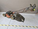 a lawn mower that is sitting on the ground