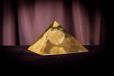 an image of a golden pyramid sitting on top of a table
