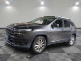 the jeep cherokee is parked in a large room with a checkered floor
