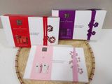 three boxes of perfume sitting on top of a wicker basket