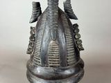an image of a black vase with a bird on it