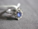 a ring with a blue sapphire and white diamonds on it