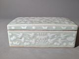 a white box with flowers on it sitting on a table