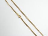 a gold chain with a clasp on a white background