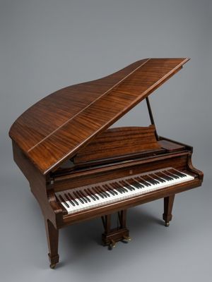 an image of a grand piano on a grey background