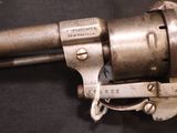 a close up of a gun on a black surface