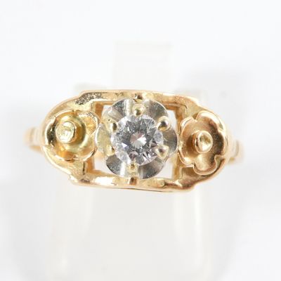 an image of a gold ring with a diamond in it