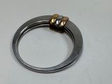 a silver ring with a gold bead on it