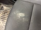 the dirty seat of a car with dirt all over it