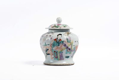 un petit vase avec un couvercle posé sur une surface blanche