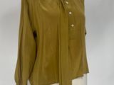 olive green shirt on a mannequin stand with a white background
