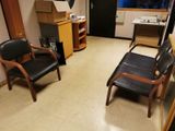 two chairs in a small room with a desk and a chair