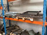 a rack of metal items in a warehouse with pallets