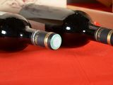 two bottles of wine sitting next to each other on a table