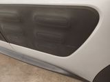 the front door of a white car with black trims