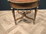 a small table with a wooden top on a wooden floor