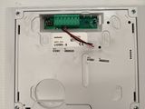 an image of a close up of a white electronic device on a table