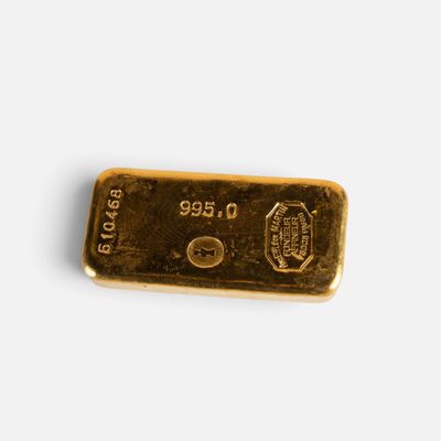 a close up of a gold bar on a white surface
