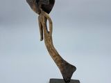 an image of a sculpture of a woman holding a hat