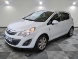 a picture of a small white car parked in a garage