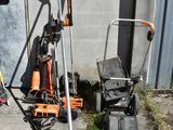 a lawn mower and a lawn mower stand in front of a building